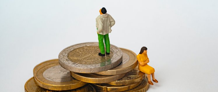 Estranged couple sitting on pile of coins